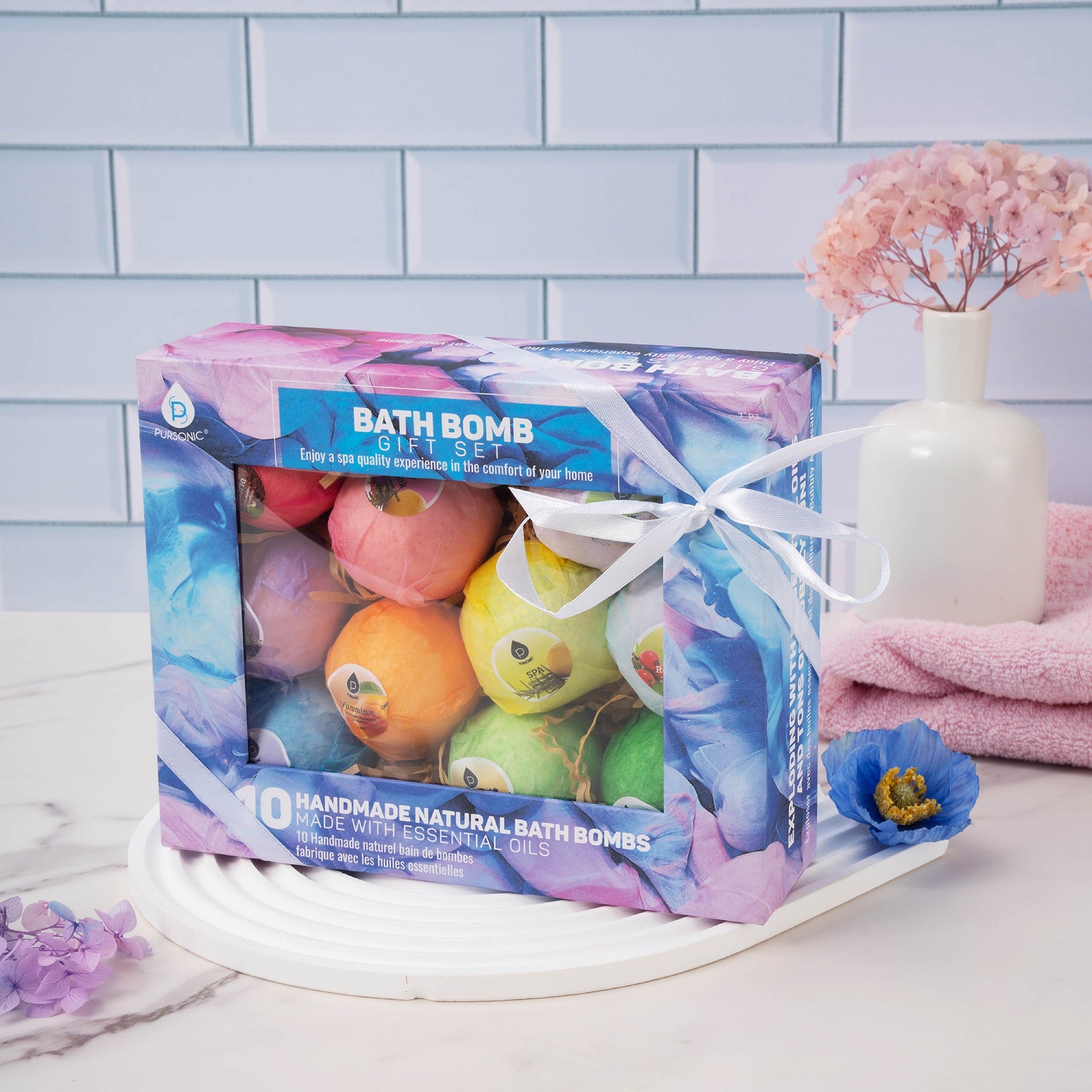 Bath bomb gift set with colorful bath bombs in a decorative box on a white surface with a light blue tiled wall background.