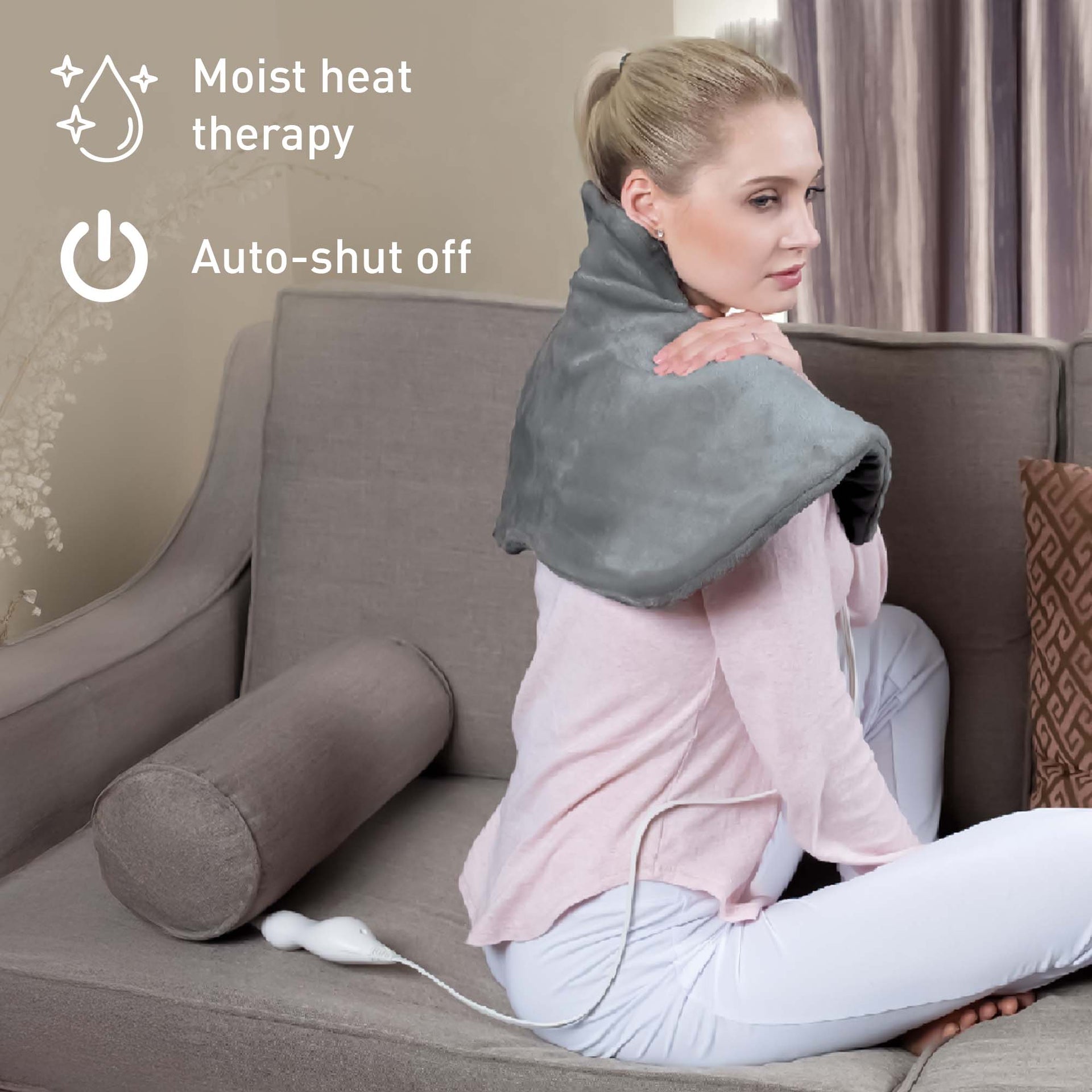 Woman using a gray heating pad on her shoulders with text 'Moist heat therapy' and 'Auto-shut off'.