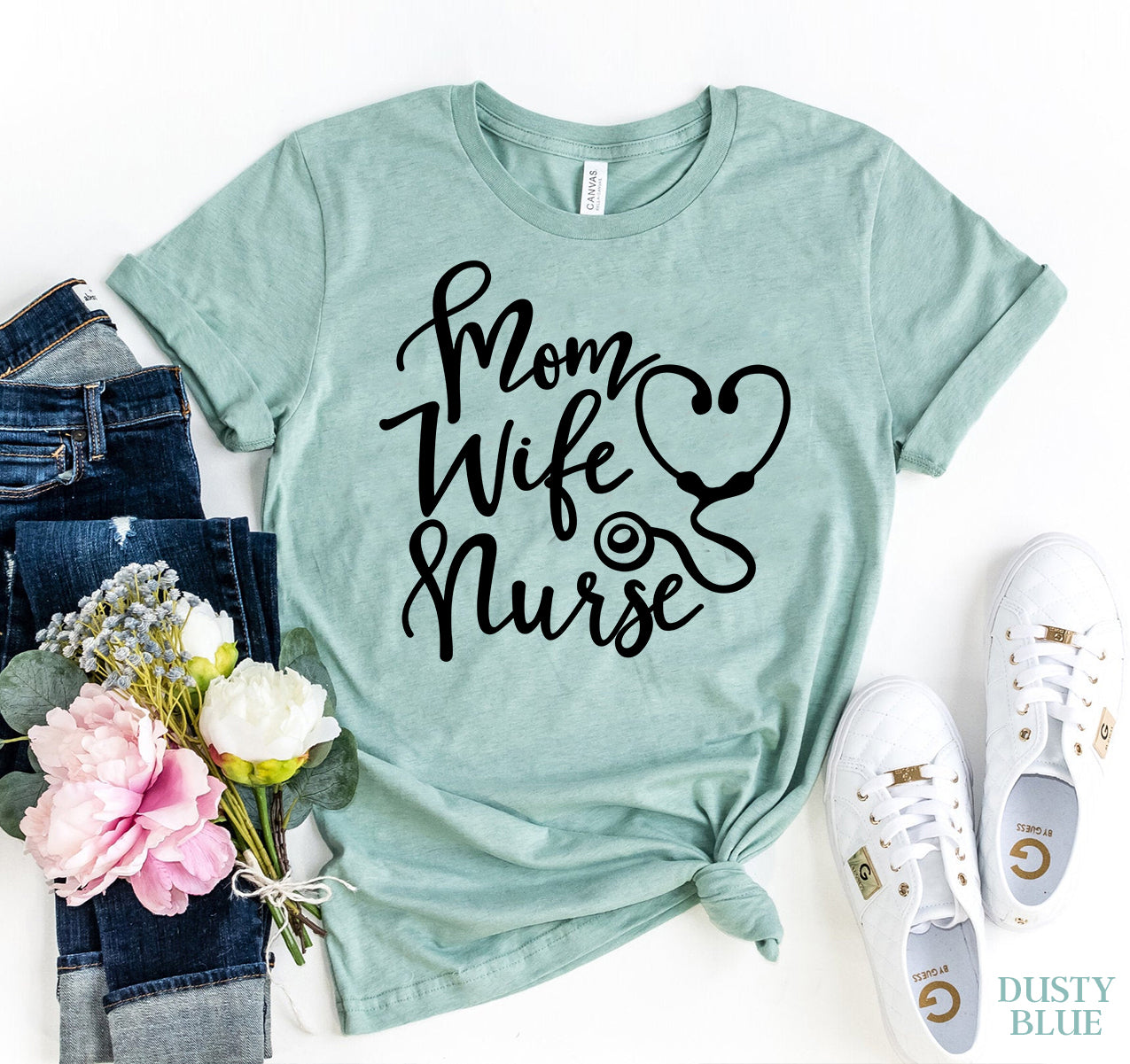 Dusty blue t-shirt with 'Mom Wife Nurse' text, jeans, sneakers, and flowers on a white background