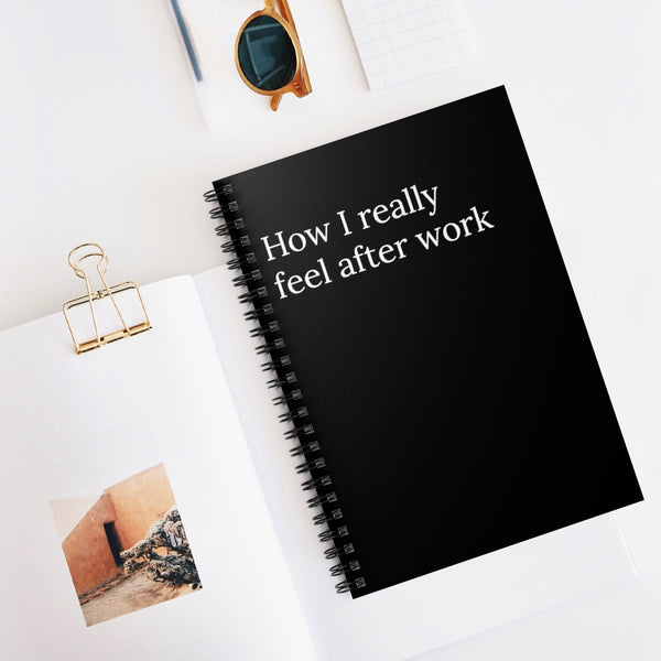 black covered paper notebook with the words How I really feel after work written on the front and photos surrounding it