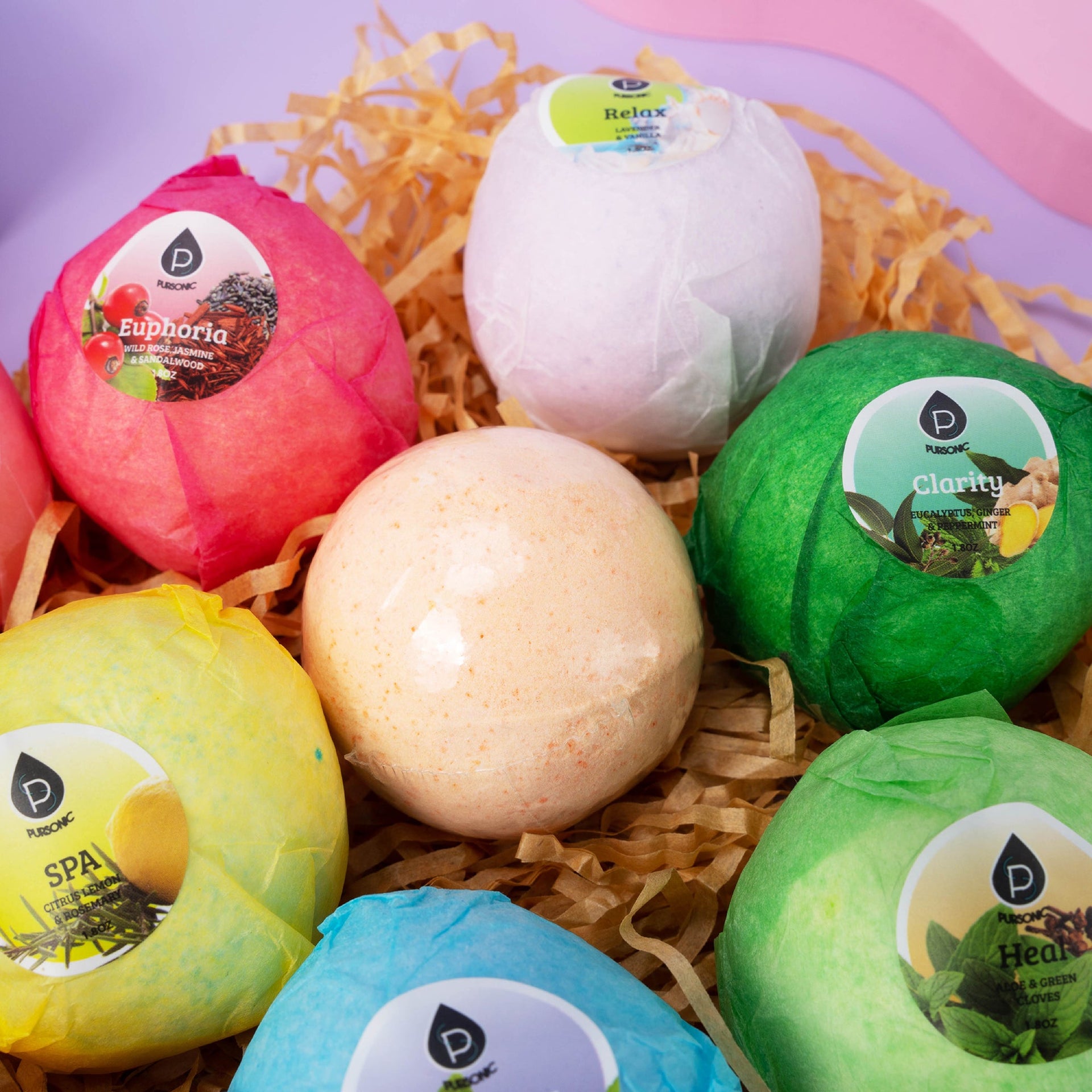 Colorful bath bombs with labels on a bed of straw