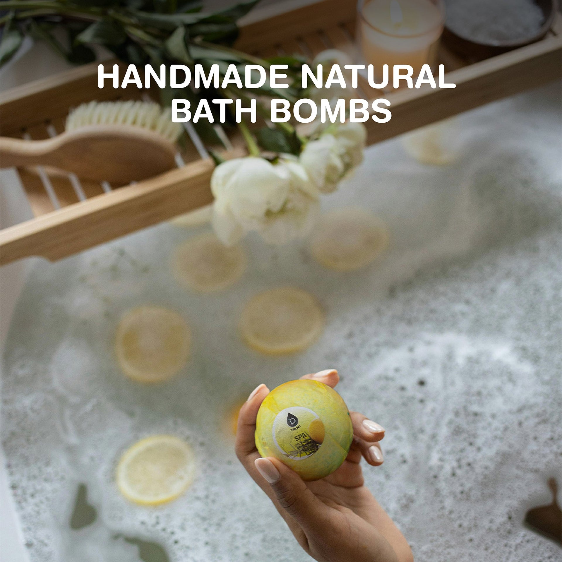 Handmade natural bath bombs with a hand holding one, surrounded by lemons and flowers in a bathtub.