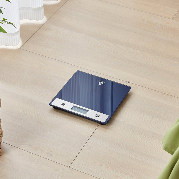 Blue digital kitchen scale on a wooden floor