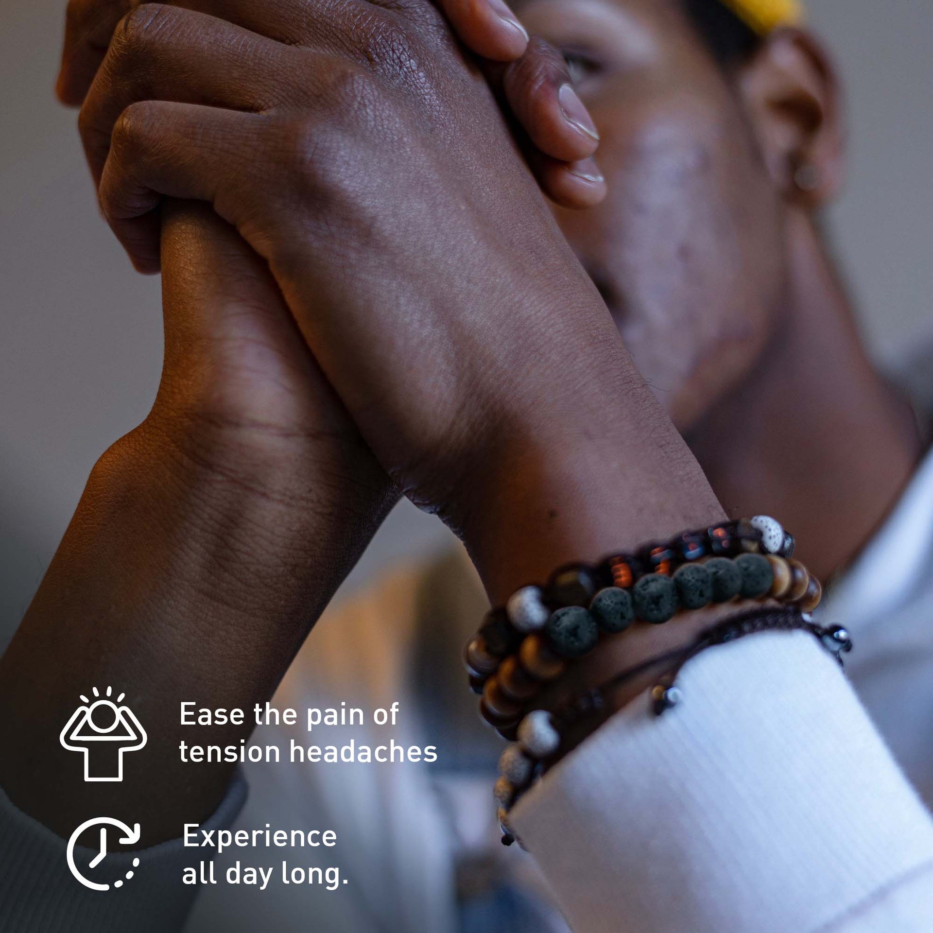 Person wearing multiple bracelets with text about headache relief.