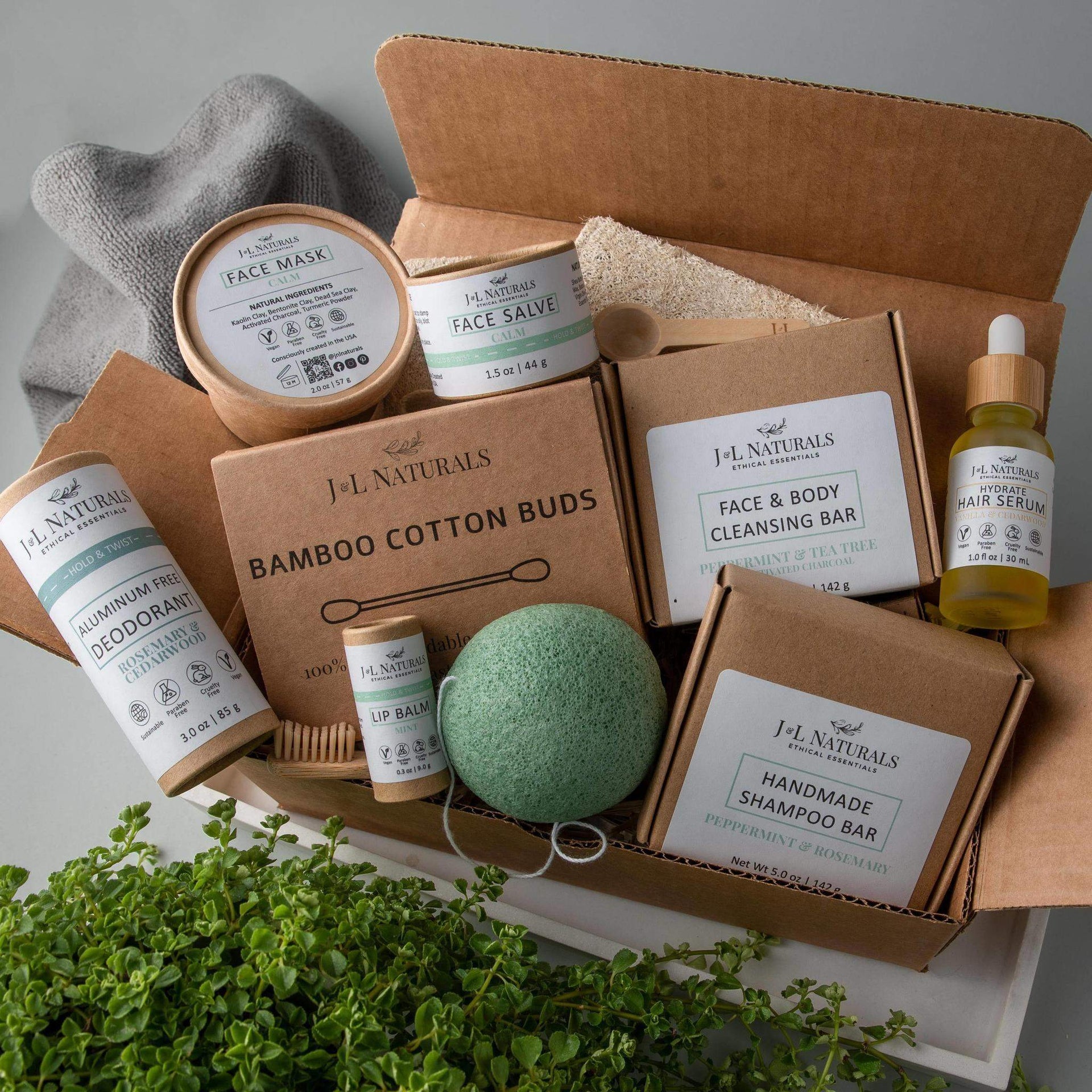 J&L naturals deluxe self care set soaps, toothbrush, shampoo bar, deoderant, cotton swabs, kojnac sponge, face mask