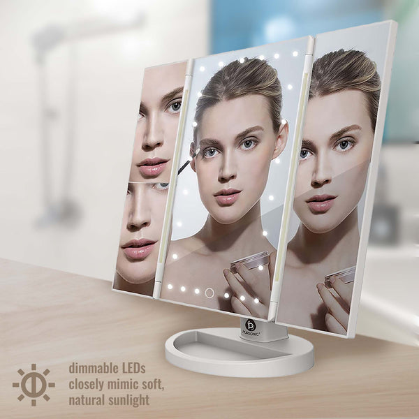 Tri-fold makeup mirror with LED lights on a wooden surface