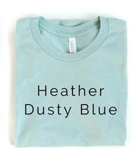 Folded heather dusty blue t-shirt with text label on a white background