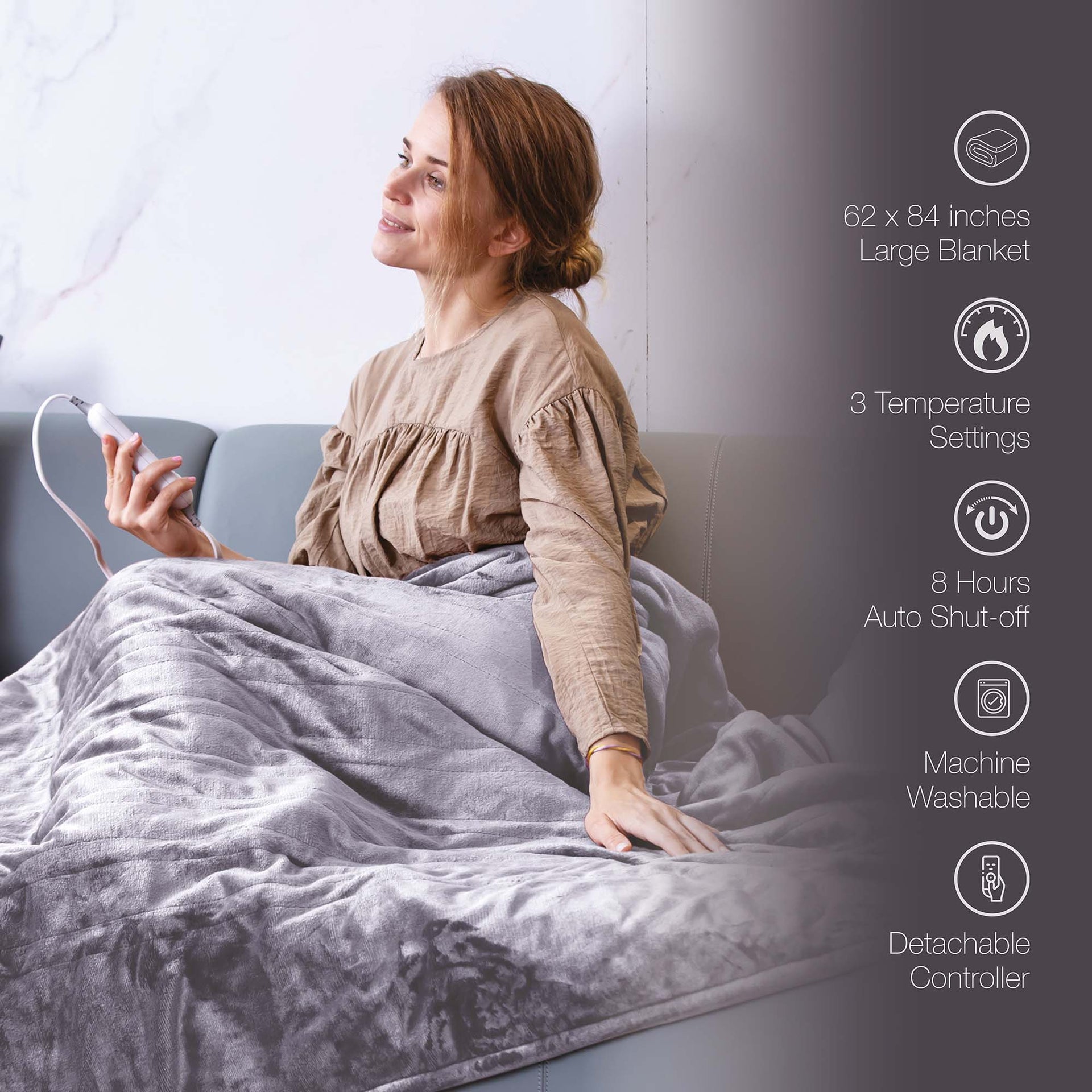 Woman using a large electric blanket with product features displayed on the side.