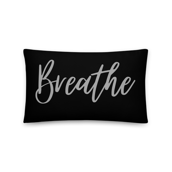 black pillow with the word breathe written on it.