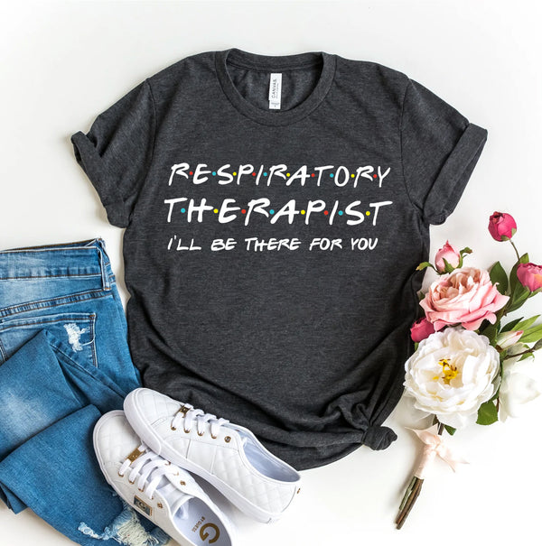 Dark gray t-shirt with 'Respiratory Therapist I'll be there for you' text, paired with jeans and sneakers on a white background.Soft cotton respiratory therapist t-shirt with I’ll Be There For You message, designed for RTs, caregivers, and lung health supporters