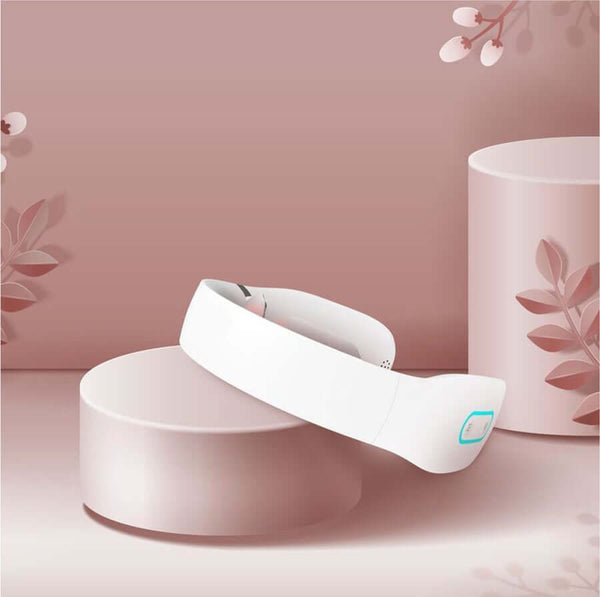 neck massager on a pink pedestal