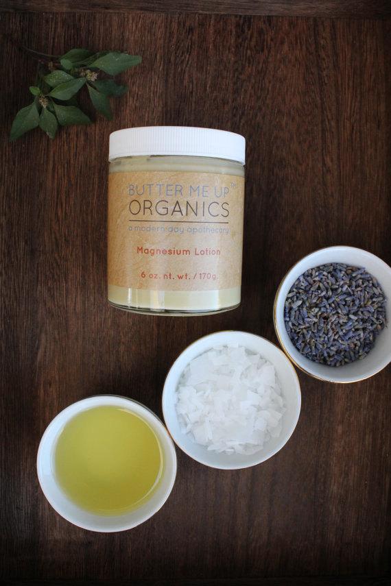 butter me up organics magnesium lotion on a shelf with decorative plants surrounding it