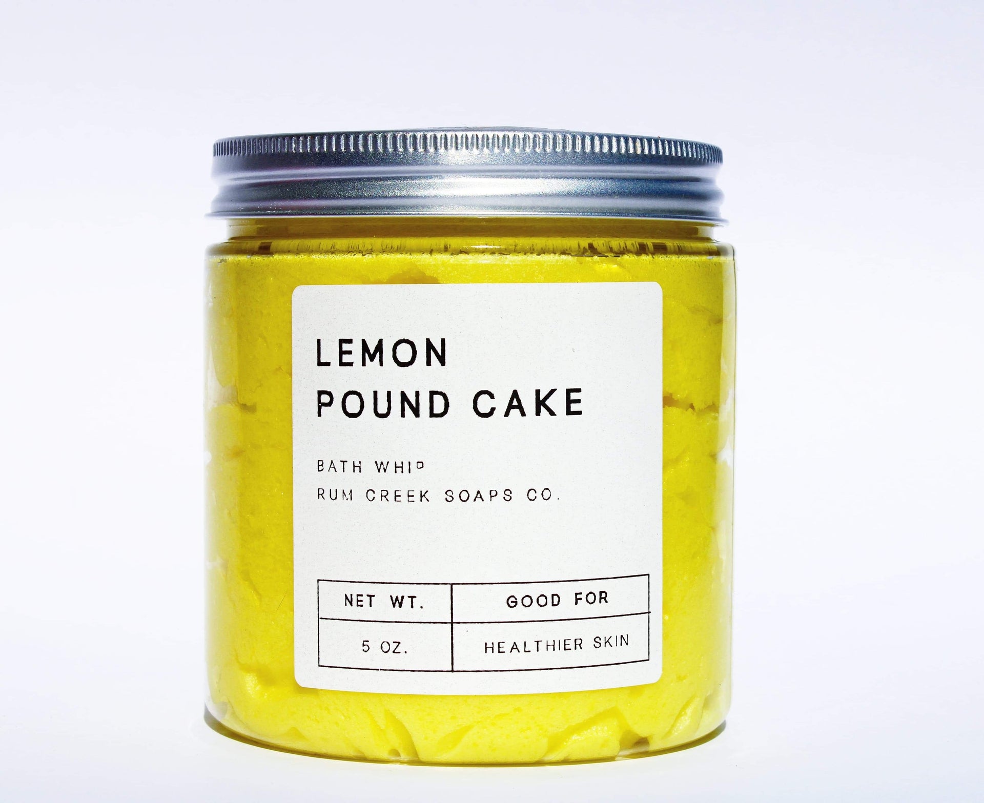 yellow whipped soap in a clear jar with tin cover