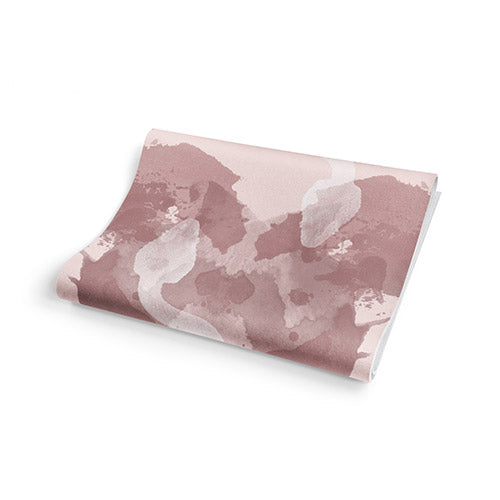 Pink and white patterned fabric on a white background.Grippy bottom of double-sided travel yoga mat for stable use on different surfaces