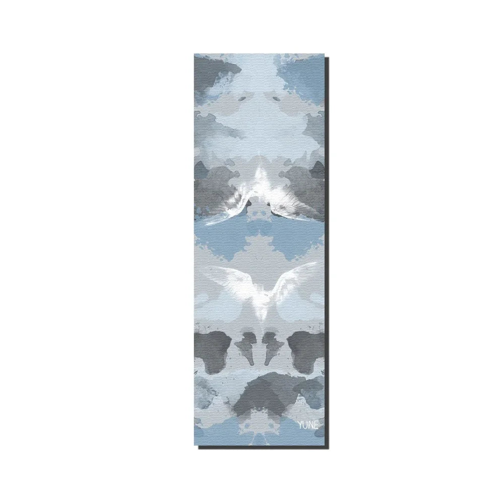 Yoga mat with mountain and animal design on a white background
