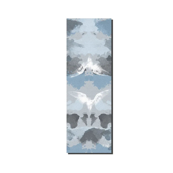 Yoga mat with mountain and animal design on a white background
