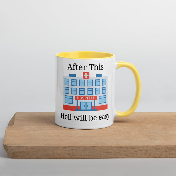 white coffee mug with yellow handle and inside with a picture of a hospital and the words that say 